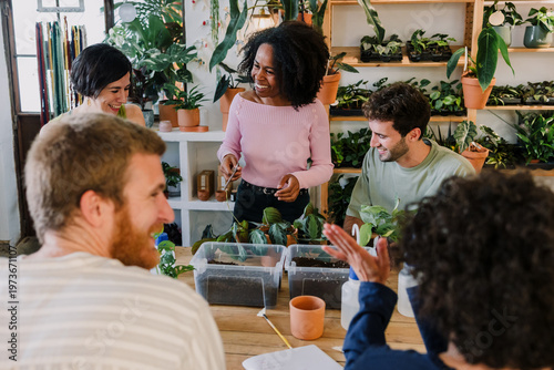 Canvas Print Diverse group of young hispanic people in gardening and planting in a plant care class together in plant shop