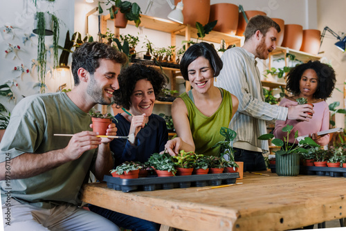 Obraz na plátně Diverse group of young hispanic people in gardening and planting in a plant care class together in plant shop