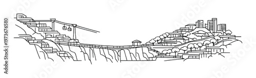 Bridge spanning canyon with cable cars and lit hillside town