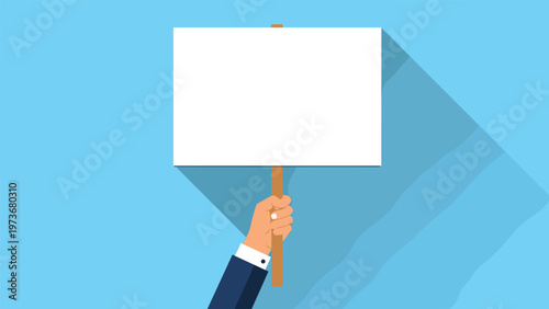 Businessman hand holding a blank white rectangular protest sign on a stick against a light blue background for copy space.
