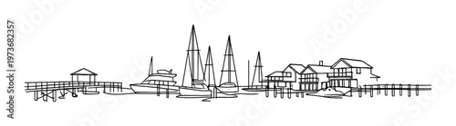 Pier with boats moored and waterfront houses along coastal shoreline