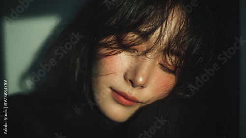 Full-body portrait of a slim adult Korean woman relaxing at home, captured in soft natural light. She smiles gently with eyes closed, expressing quiet happiness and comfort. The scene features a blurr