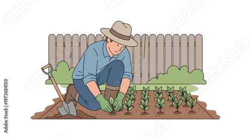 Gardener planting seedlings in a garden bed with a fence and bushes in the background