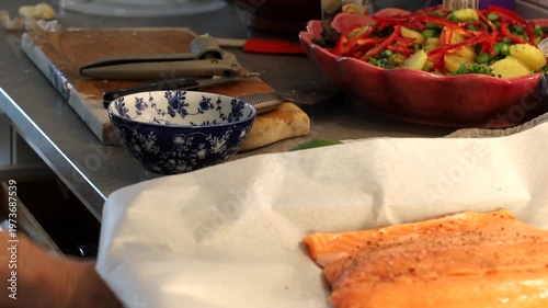 Stockholm, Sweden A cook prepares a side of salmon in a domestic kitchen for a dinner party.