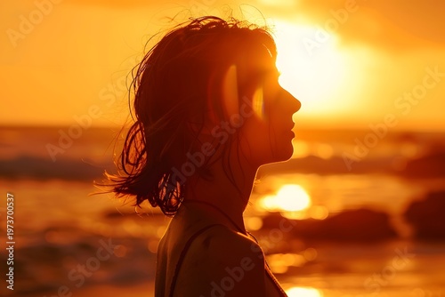 Woman profile silhouette at sunset on beach with ocean waves and warm golden light summer lifestyle concept