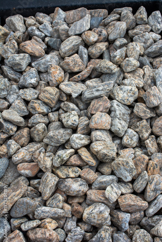 Smooth white garden pebbles texture with dark border background