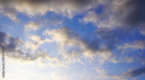 a clear afternoon sky with white and black clouds
