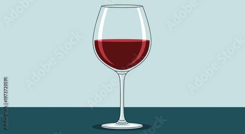Single elegant glass of red wine is placed on a dark surface against a soft blue background highlighting its rich color and clarity.