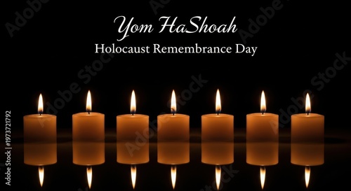 Seven glowing candles reflecting on a dark background for the annual yom hashoah commemoration