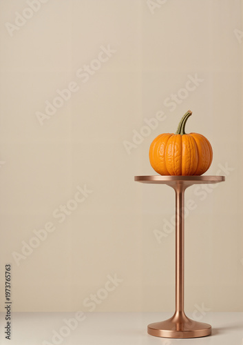 Orange pumpkin displayed on modern stand against neutral background for Thanksgiving  