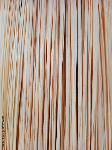 Close-up of a raffia lampshade. Warm wicker background. Boho-chic style crafts and accessories. Basketry and decor.