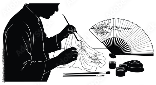 Artist painting traditional floral pattern on silk fan black white