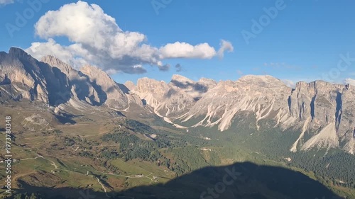 Panoramic view of the UNESCO Dolomites Park against the backdrop of blue sky and mountains.