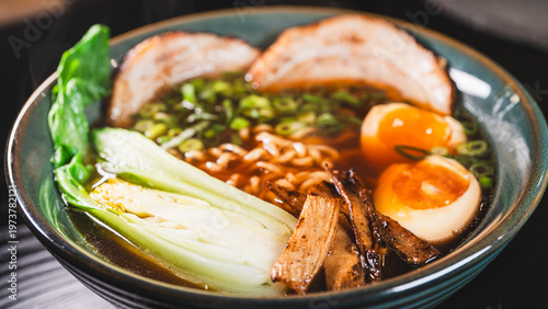 Creative homemade ramen using instant noodles combined with tender chashu pork belly, soft boiled egg, fresh bok choy, bamboo shoots and scallions in a rich pork broth with soy umami flavor. Fusion of
