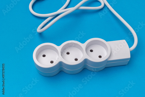 Foto Triple Outlet Power Strip on Vibrant Blue Background