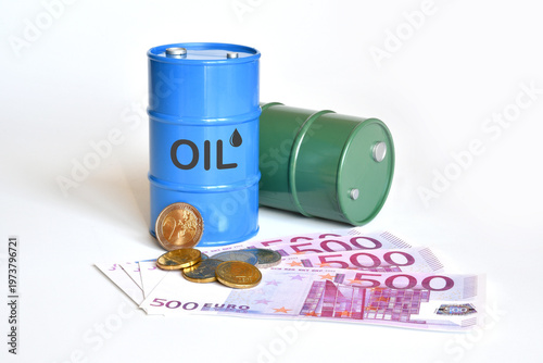 Model of oil barrels over Euro banknotes and coin. A concept image for rising oil prices.