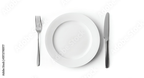 Empty white plate with silver fork and knife on plain background ready for meal