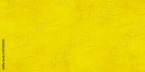 A textured yellow grunge wall background with aged parchment paper patterns and a vintage rough canvas design for a blank wallpaper backdrop