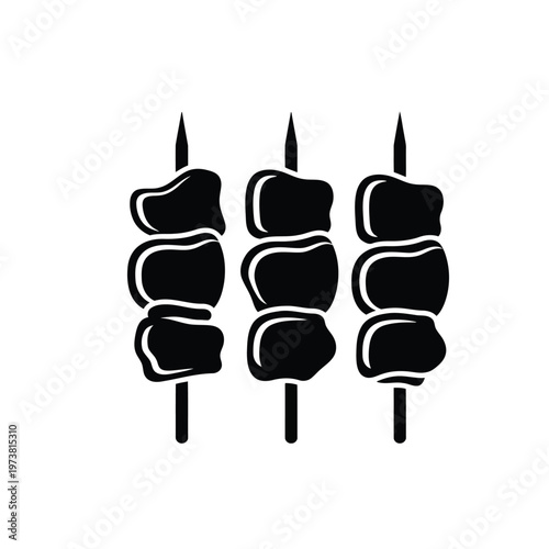 Grilled meat skewers with chunks of beef on sharp pointed sticks