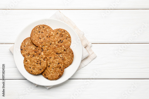 Tasty oatmeal cookies on white wooden table, top view. Space for text