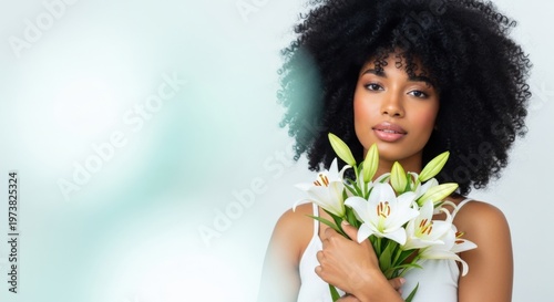 South African woman with Easter lilies, smiling, on a soft blurred background, copy space