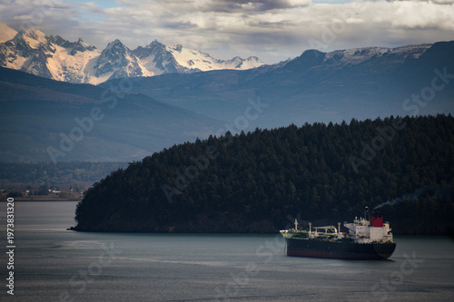 Oil Tanker anchored in Fidalgo Bay with Mt. Baker and Padilla Bay in the background. Seen from Cap Sante Park in the city of Anacortes, Washington.