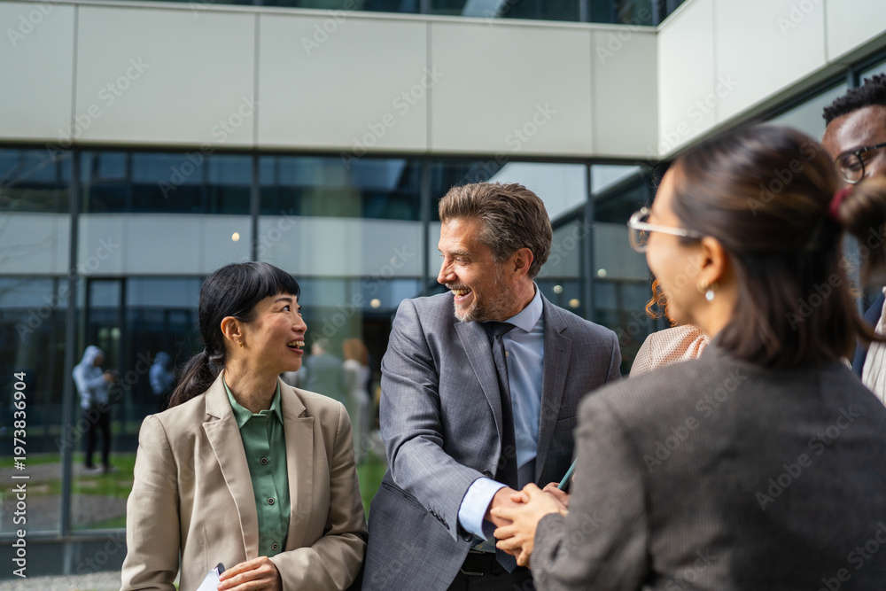 Obraz premium Diverse business professionals shaking hands at formal meeting