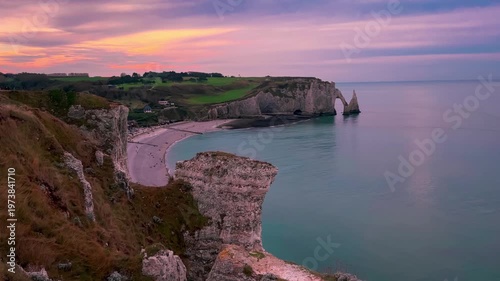 Sunset view from above of chapel and picturesque coastal limestone cliffs and the English Channel town of Etretat, Normandy, France. High quality 4k footage