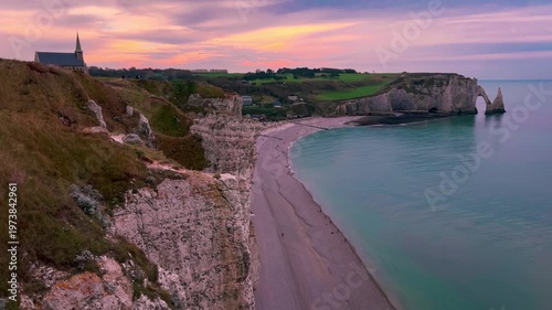 Sunset view from above of chapel and picturesque coastal limestone cliffs and the English Channel town of Etretat, Normandy, France. High quality 4k footage