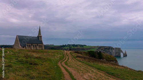 Sunset view from above of chapel and picturesque coastal limestone cliffs and the English Channel town of Etretat, Normandy, France. High quality 4k footage