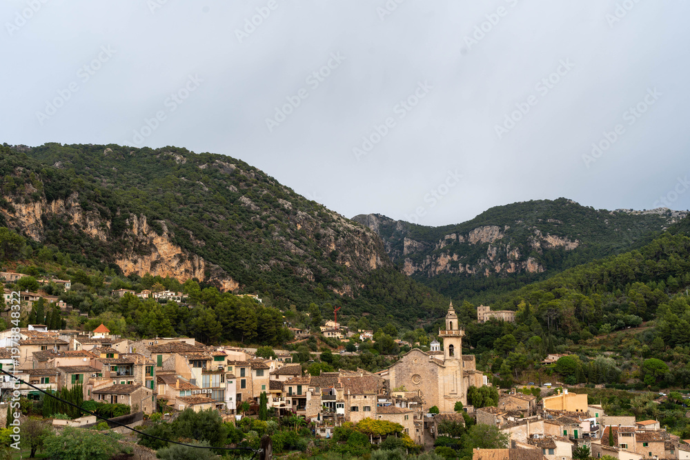 Obraz premium Mediterranean village with church in mountain valley landscape