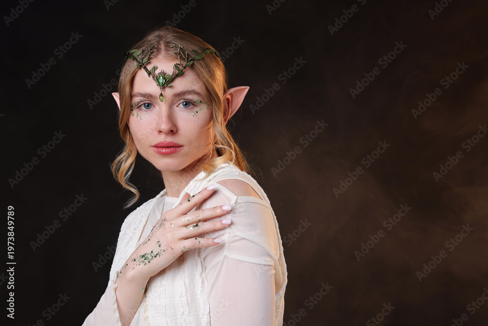 Obraz premium Beautiful elf girl on black background with smoke, space for text