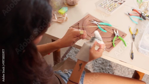Jewelry designer cleaning wire with a cloth