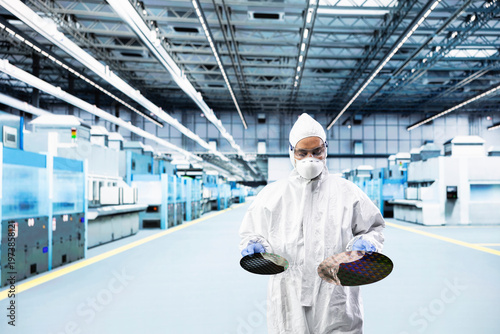Photos Indian man inspecting semiconductor production infrastructure, optimizing photolithography process