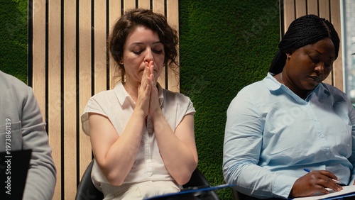Scared impatient woman applicant getting extremely nervous and agitated while she waits in the queue outside HR office. Person sitting in line under pressure, deals with anxiety.