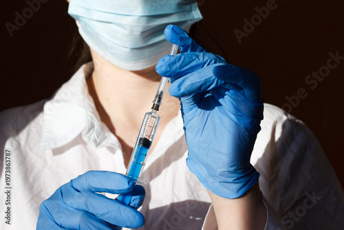 Medical worker with syringe before injection. Injections and treatment