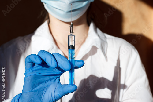 Medical worker holds a syringe in his hands. Medical business. Injections