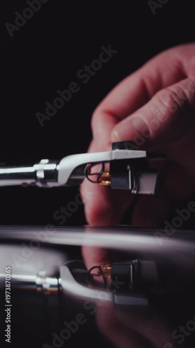 Vinyl turntable needle being placed onto a record vertical portrait video