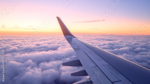 Minimal airplane wing view above soft clouds at sunrise with clean sky gradient and large copy space. Perfect for travel, aviation, and business journey concepts with a calm, modern aesthetic.