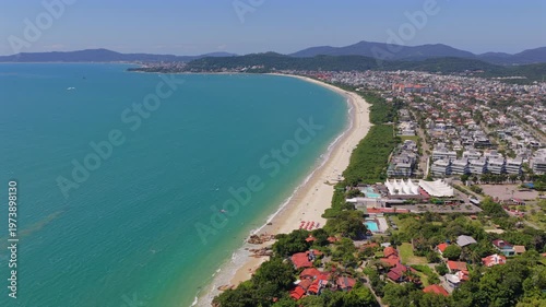 Turquoise waters and white sand of Jurere Internacional beach, Florianopolis, Brazil.