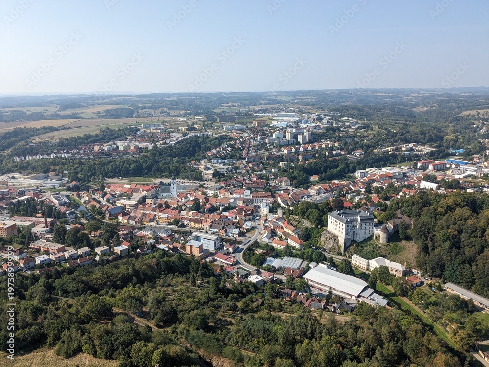 Fototapeta premium Aerial panorama of Velke Mezirici Castle in the Vysocina region,castle complex, showing historic architecture and surrounding town landscape from above
