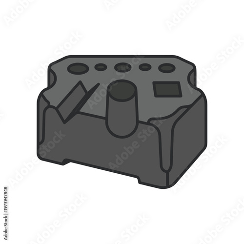 Stylized dark gray block or module with various circular holes, rectangular recesses, and cylindrical protrusions on its top surface, shown in a flat illustration style.