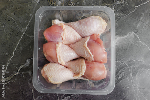 Fresh chicken drumsticks ready for cooking in a modern kitchen setting