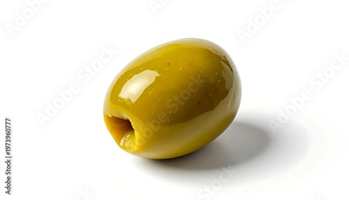 A single green olive with a pit hole on a white background