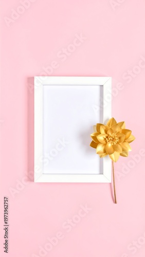 A white frame with a golden flower on a pink background