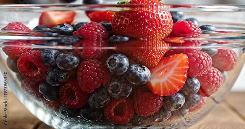 Fresh mixed berries in glass bowl.