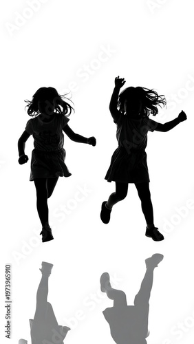 Two girls jumping playfully with reflected shadows