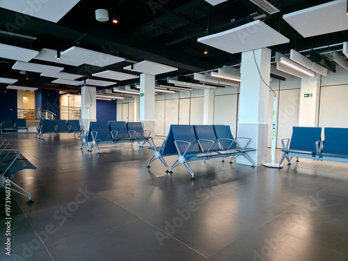 Modern empty airport waiting room with blue seats