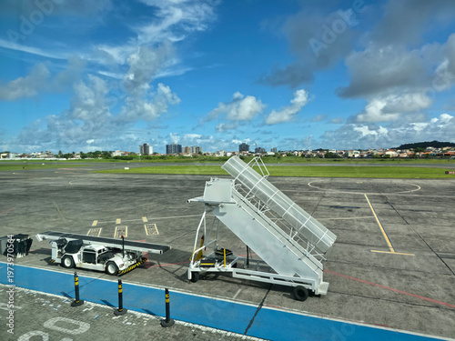 Mobile boarding stairs and airport service vehicle on apron at Jorge Amado Airport in Ilheus Bahia