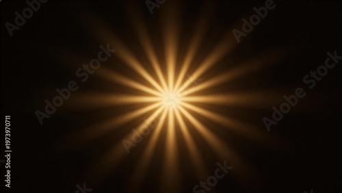 Golden starburst light on black background